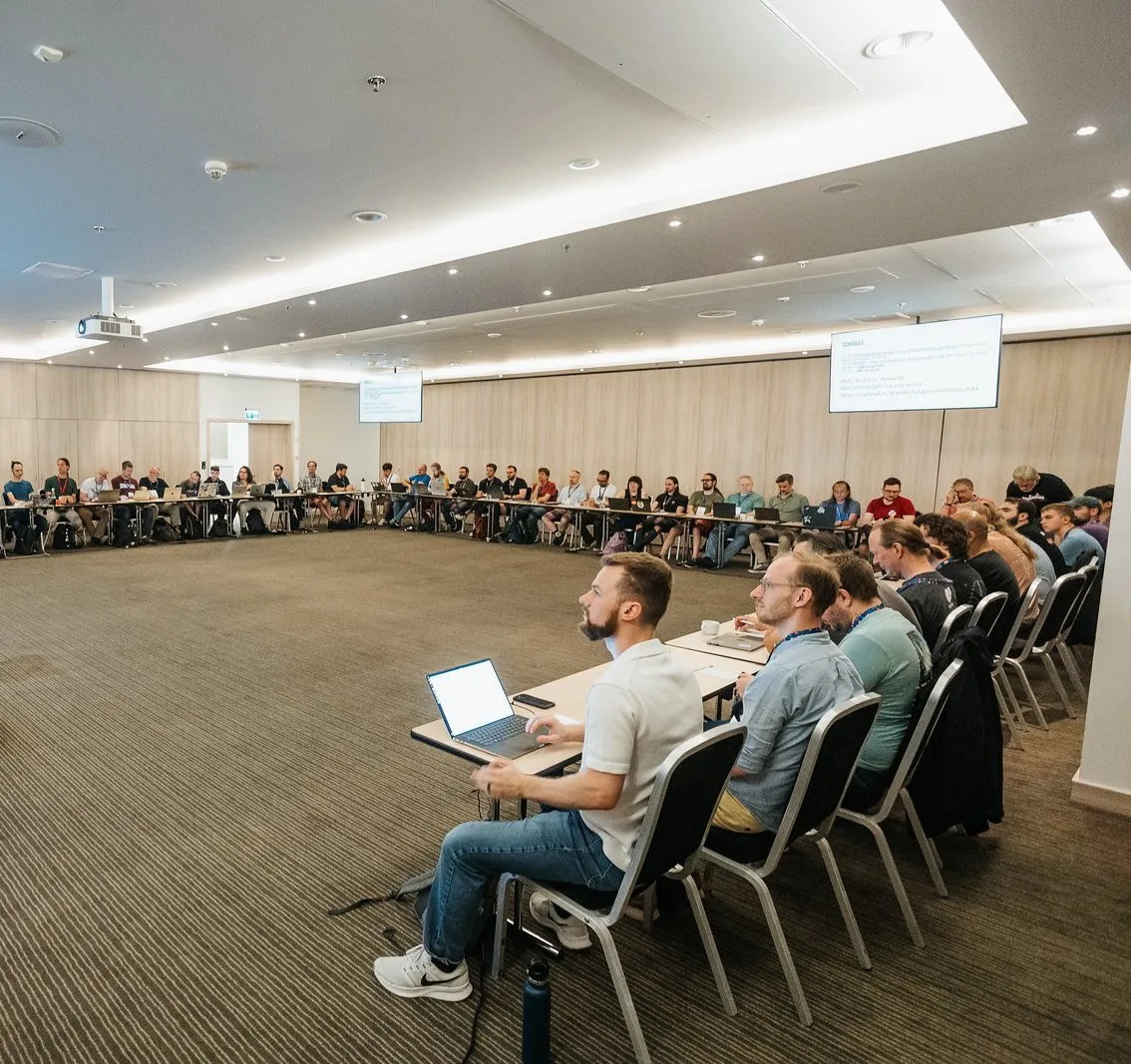 A wide view of the Language Summit room, with attendees around the U-shaped table
